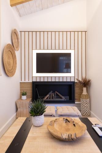 a living room with a television above a fireplace at Zoella Earth Suites in Preveza