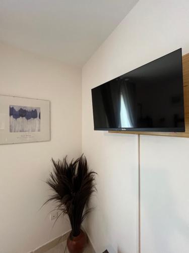 a living room with a flat screen tv on a wall at St Pasha in Paillé