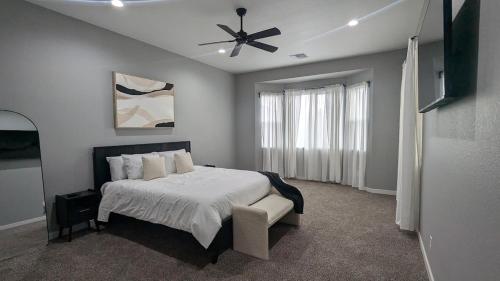 a bedroom with a bed and a ceiling fan at Spacious 5 BD Luxury Getaway Near Westgate in Glendale