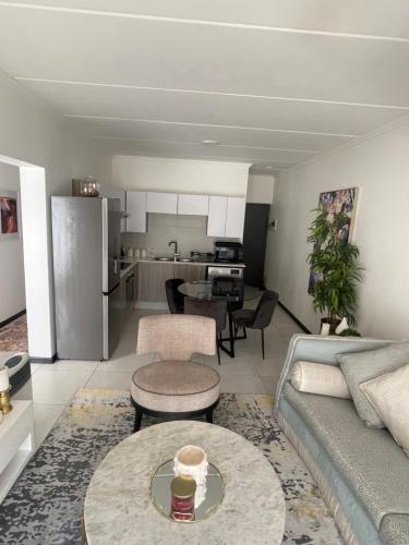 a living room with a couch and a table at ventura 250 in Sandton