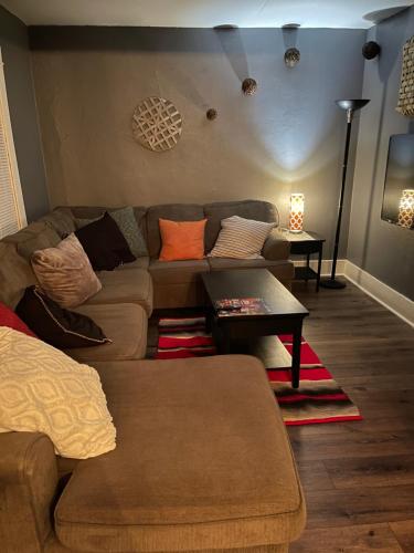 a living room with a couch and a table at yellow house downtown in Des Moines