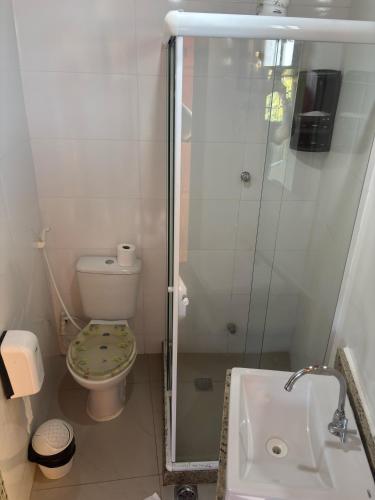 a bathroom with a shower and a toilet and a sink at Atobás in Arraial do Cabo