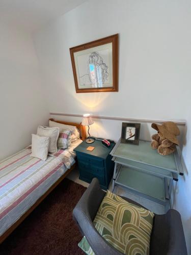 a bedroom with a bed and a table and a chair at St Pasha in Paillé