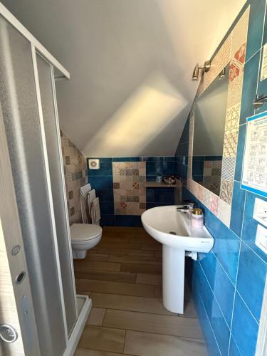 a bathroom with a sink and a toilet at Agriturismo Un Mare di Fiori in Ventimiglia