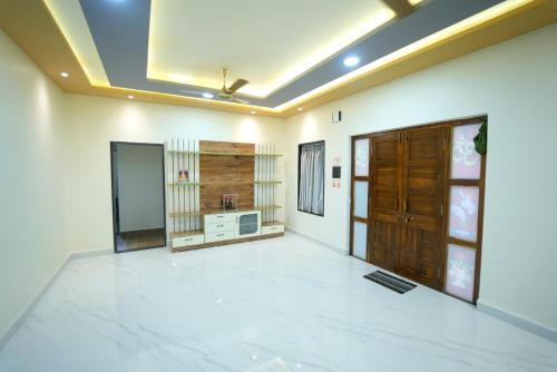 a large living room with white walls and a ceiling at Kashid Farmhouse junnar in Junnar