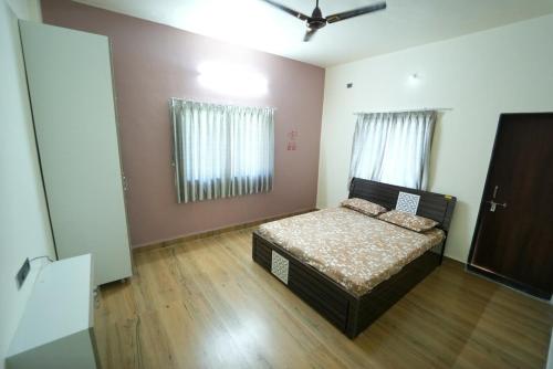 a bedroom with a bed in the middle of a room at Kashid Farmhouse junnar in Junnar
