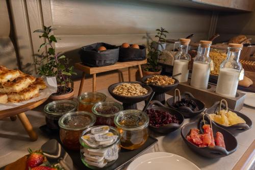 a table topped with bowls of food and other foods at Zoella Earth Suites in Preveza