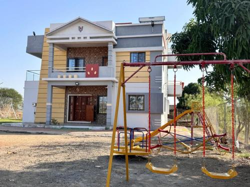 a playground in front of a house at Kashid Farmhouse junnar in Junnar