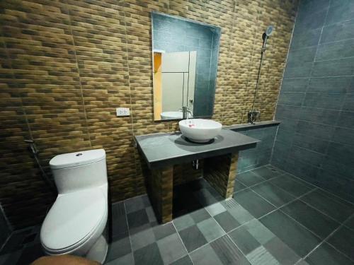 a bathroom with a sink and a toilet and a mirror at Sunny Side Resort Koh Tao in Koh Tao