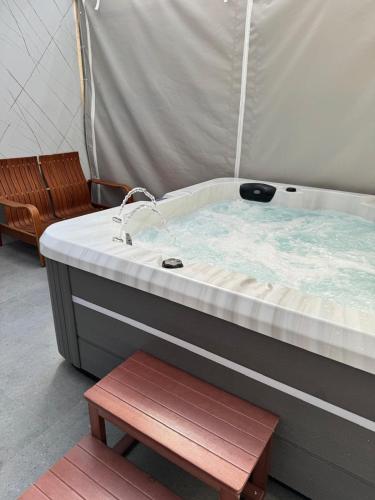 a hot tub with a sink and a bench at Квартира in Nahariyya