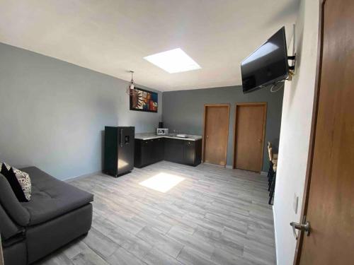 a living room with a couch and a flat screen tv at Apartment10 minutes APTGDL in Guadalajara