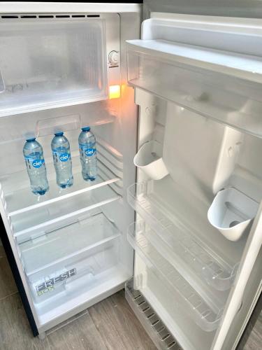 two bottles of water in an open refrigerator at Apartment10 minutes APTGDL in Guadalajara