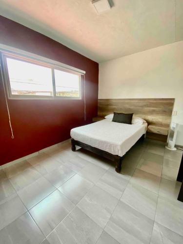 a bedroom with a bed and a window at Apartment10 minutes APTGDL in Guadalajara