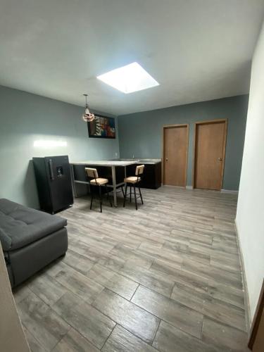 a large room with a table and chairs and a couch at Apartment10 minutes APTGDL in Guadalajara