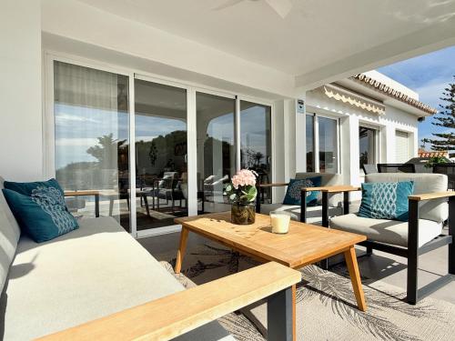 a living room with a couch and a table at Villa Ibiza by Solrentspain - La Cala de Mijas in Mijas Costa