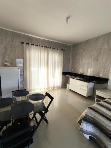 a bedroom with a table and chairs and a bed at Vista da Serra in Penedo