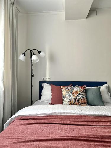 a bedroom with a bed with pillows on it at Студия ПРОВАНС в центре Алматы in Almaty