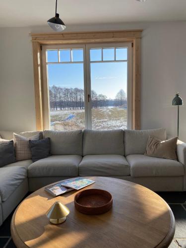 a living room with a couch and a coffee table at Dom nad Buwełnem in Marcinowa Wola