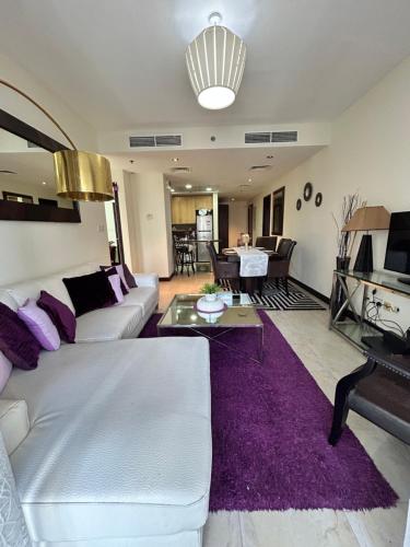 a living room with a white couch and a purple rug at Click Stay - JLT - 2 Bedroom & Balcony Lakes view Entire Apartment -AZ in Dubai