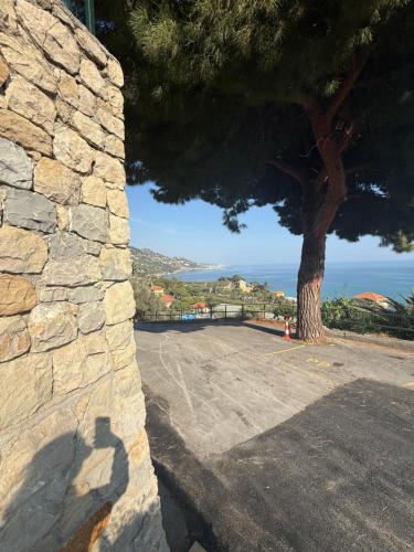 a shadow of a person standing next to a stone wall at Agriturismo Un Mare di Fiori in Ventimiglia
