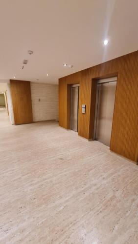 a large empty room with wooden walls and a wooden floor at Centar Balkan Square in Zlatibor