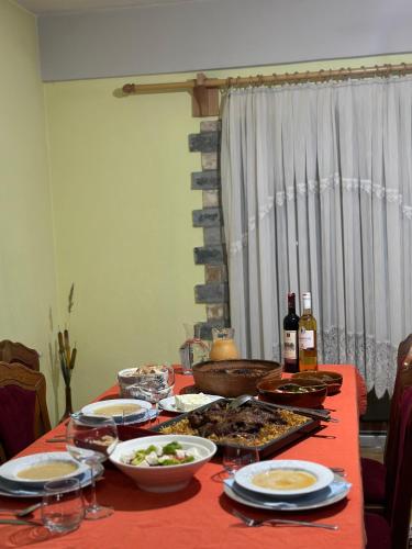 a table with food and bottles of wine on it at konaku in Tomin
