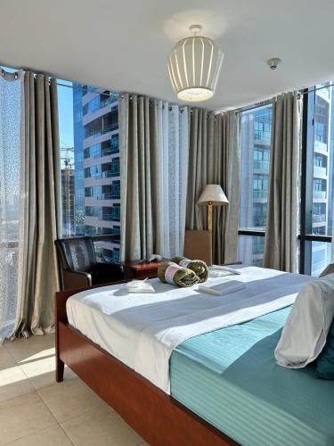 a bedroom with a large bed and a large window at Click Stay - JLT - 2 Bedroom & Balcony Lakes view Entire Apartment -AZ in Dubai