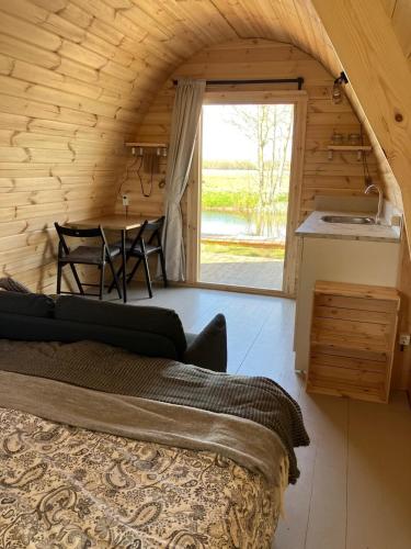 a room with a bed and a kitchen and a table at De kastanjehof 31 in Beerta
