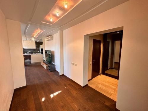 an empty living room with a hard wood floor at Skyhouse Riga Superior Penthouse & SPA in Rīga