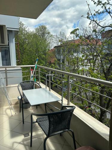 a balcony with a table and chairs on a balcony at Sandanski Apartments Top Center in Sandanski