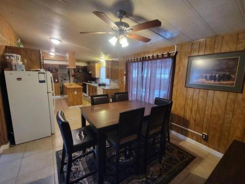 a kitchen with a dining table and a white refrigerator at Campground at Sequoia Mountain Farms - Bring Your Own Tent or RV - No Bedrooms or Beds Provided in Miramonte