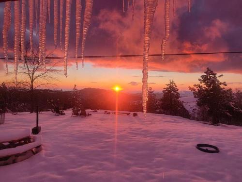 a winter sunset with icicles hanging from a ski lift at Campground at Sequoia Mountain Farms - Bring Your Own Tent or RV - No Bedrooms or Beds Provided in Miramonte