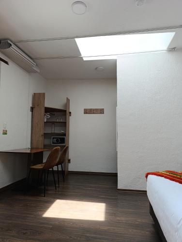 a bedroom with a desk and a bed and a table at Casona Tobar Hotel in Quito