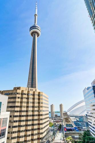 a view of the cn tower in a city at RHD Luxury Condos-Downtown, CN Tower, Metro Toronto Convention Centre, Rogers Centre, Free Parking in Toronto