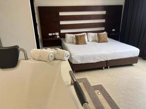 a hotel room with two beds with towels on them at Hotel Marialu in Ocaña