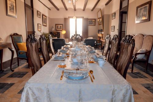 a long table with plates and glasses on it at Castell Granadella in L'Ampolla