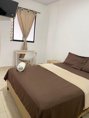 a bedroom with a large bed and a window at Daresff Imperial in Puerto Wilches