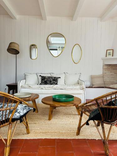 a living room with a couch and a table at Maison des terroirs - Centre village - 500 m de la plage in La Couarde-sur-Mer