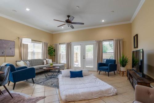 a living room with a couch and a ceiling fan at Modern DT Home-King size Bed-Patios-Long Stays-WiFi in Orlando