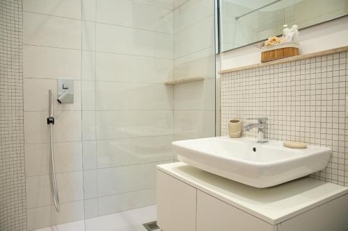 a white bathroom with a sink and a shower at Antica Piazzetta in Canneto