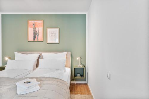 a bedroom with two beds with white pillows at WHONAP - GREEN URBAN I Business I Zentral I Dachterrasse I Küche in Neckarsulm