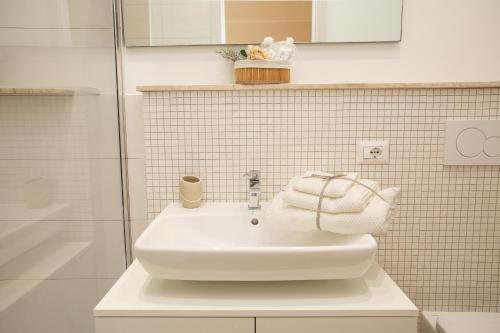 a bathroom with a white sink and a shower at Antica Piazzetta in Canneto