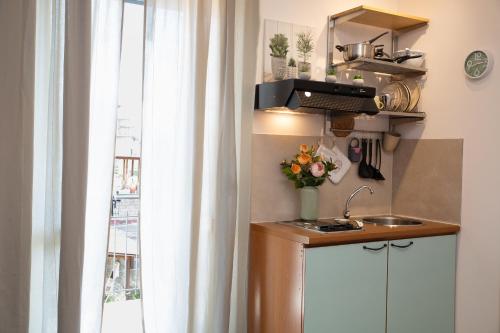 a kitchen with a sink and a window at Antica Piazzetta in Canneto