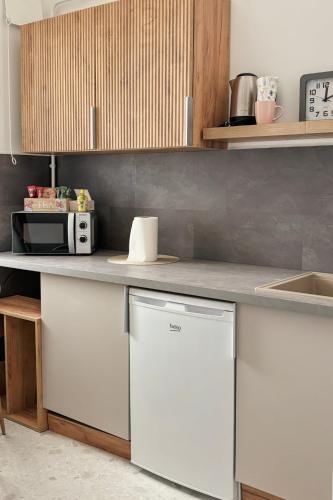 a kitchen with a counter top with a dishwasher at Middle of the city apartman 2 in Pécs