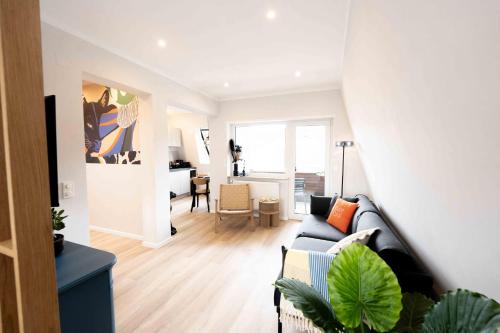 a living room with a couch and a dining room at Apartment Mayer in Wachenheim an der Weinstraße in Wachenheim an der Weinstraße