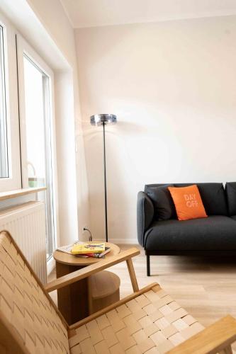 a living room with a couch and a table at Apartment Mayer in Wachenheim an der Weinstraße in Wachenheim an der Weinstraße