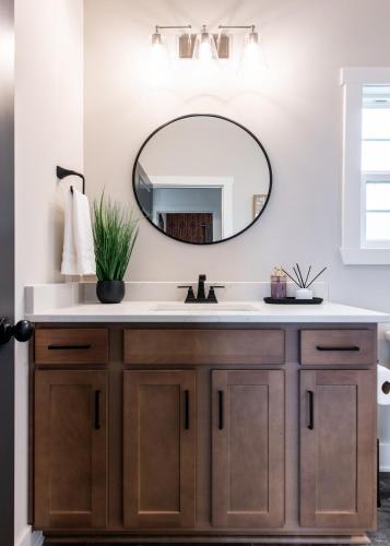 a bathroom with a sink and a mirror at Brand New House! Prime Location! in Jeffersonville