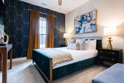 a bedroom with a king sized bed with blue walls at Brand New House! Prime Location! in Jeffersonville