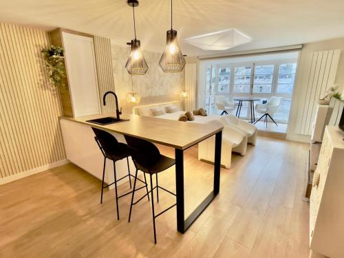 a kitchen and living room with a table and chairs at Abrazo a la Catedral by Unique Rooms in Burgos