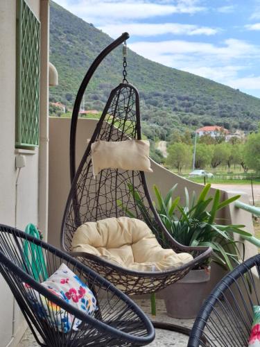 a hammock on a porch with a view of a mountain at Vitamin sea Apartment 4, Άνετο διαμέρισμα. in Almiropótamos